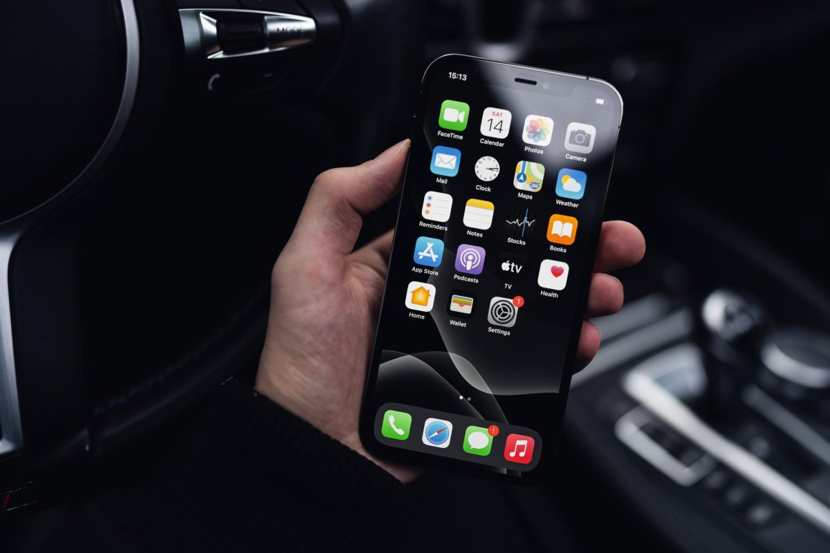 man-holding-a-smartphone-in-a-car-free-photo